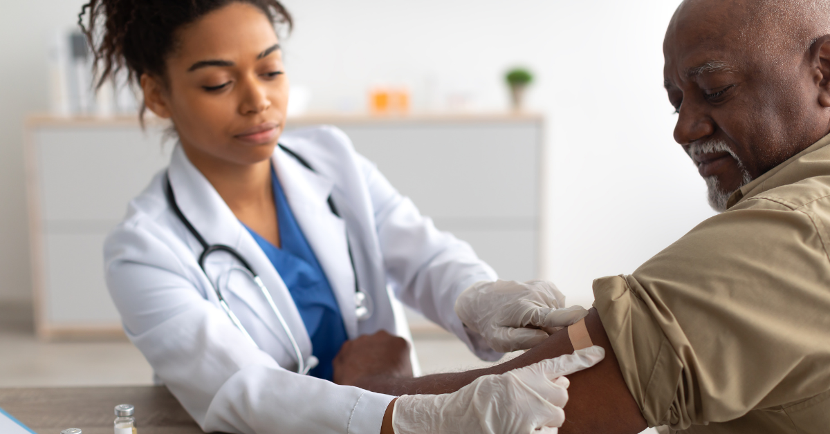 healthcare provider sits with patient